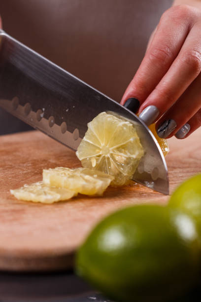 istock young woman in a gray aprons cut lemon 1144829298