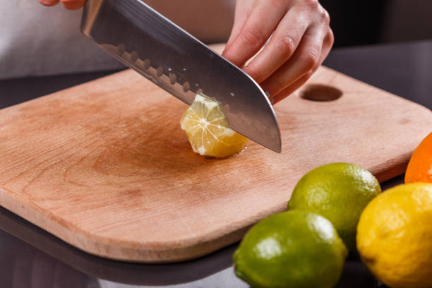 istock young woman in a gray aprons cut lemon 1144829430