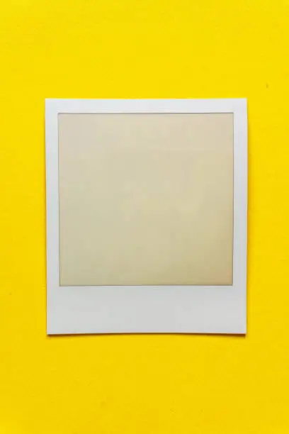 Photo of single empty or blank instant film frame or photo placeholder on real background