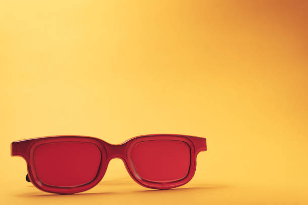 istock Red glasses on a orange table background. Summer concept. 1144829917