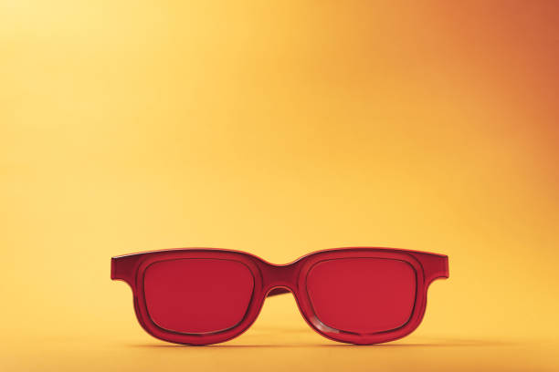 istock Red glasses on a orange table background. Summer concept. 1144829921