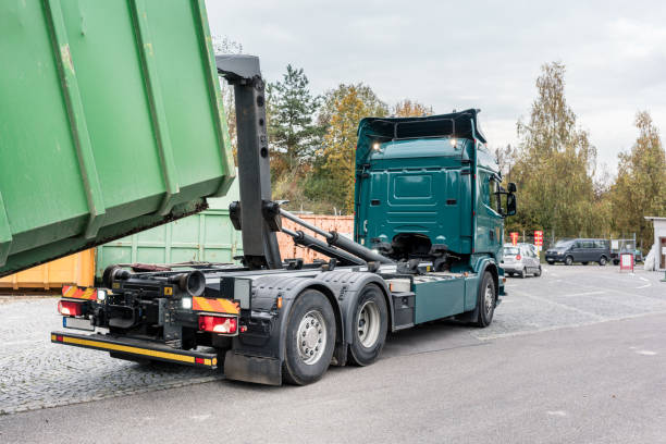 istock Truck loading container with waste green on recycling center 1144830888