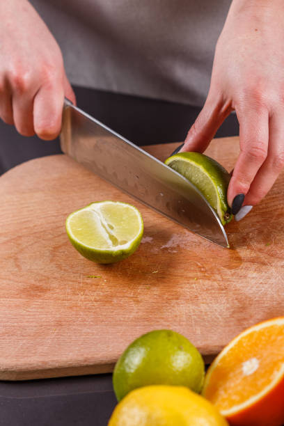istock young woman in a gray aprons cut lime 1144831055