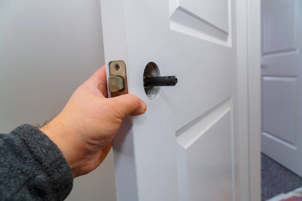 istock Hands repairing a door lock 1144831112
