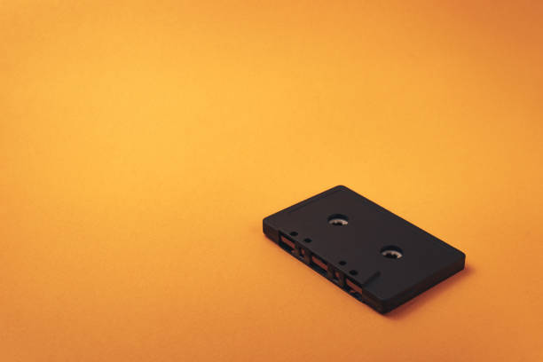 istock Black classic magnetic cassette tape on a orange background. 1144831213