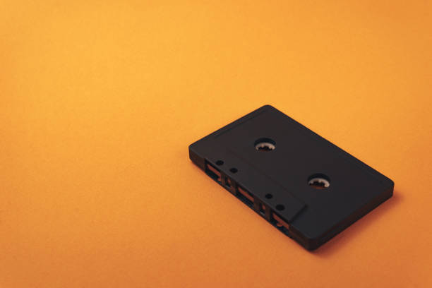 istock Black classic magnetic cassette tape on a orange background. 1144832374