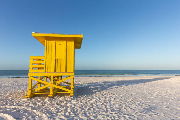 Yellow lifeguard tower on an early morning beach.  Copy space in the sky if needed.