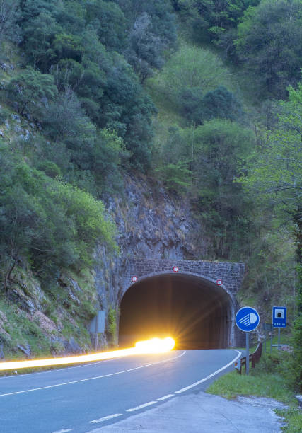 istock car lights at speed, car driving in a tunnel 1144834165