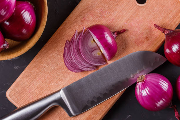 istock red onion cut on a wooden board 1144834311