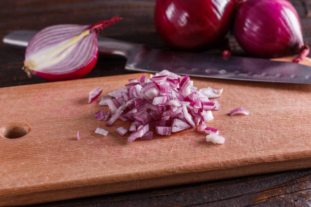 istock red onion cut on a wooden board 1144834436