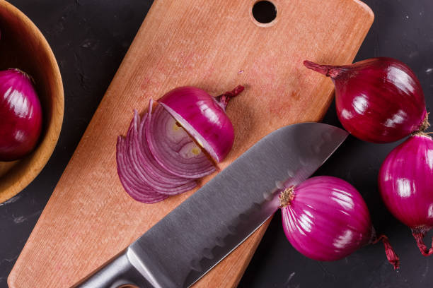 istock red onion cut on a wooden board 1144834456