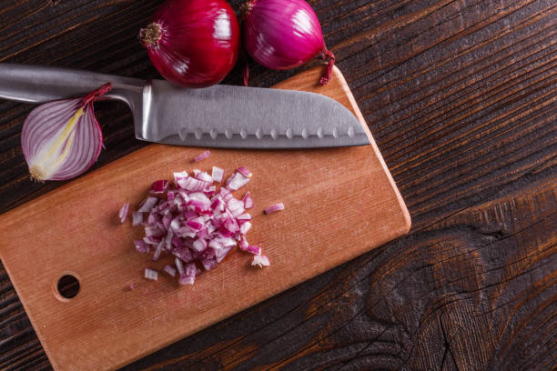 istock red onion cut on a wooden board 1144834465