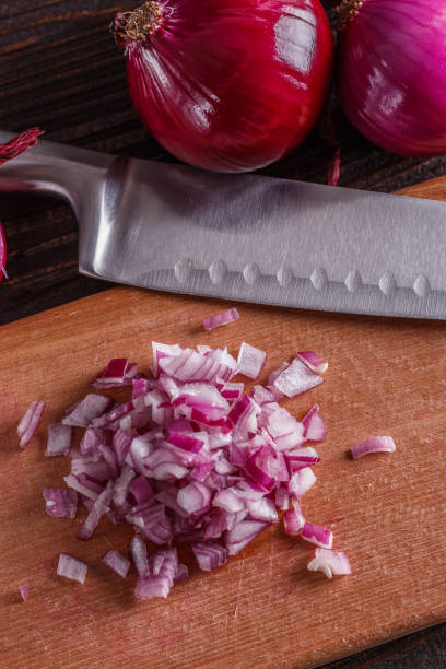 istock red onion cut on a wooden board 1144834550