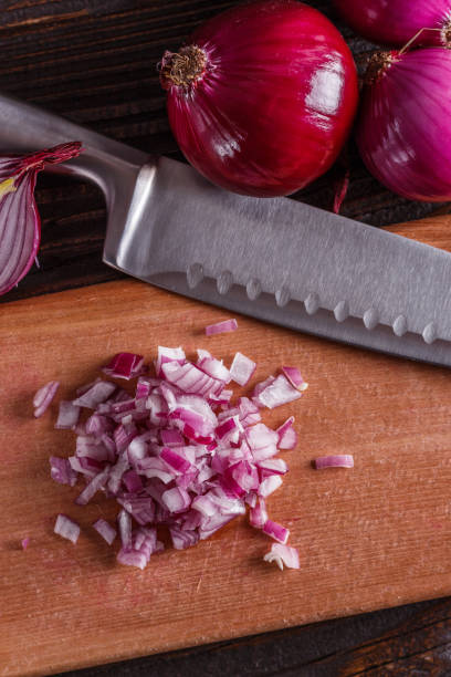 istock red onion cut on a wooden board 1144834562