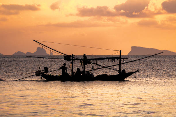 istock Fishing boat silhouette at sunset in Koh Phangan 1144834574