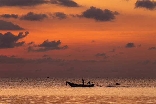 istock Fishing boat navigating at sunset in Koh Phangan 1144834594