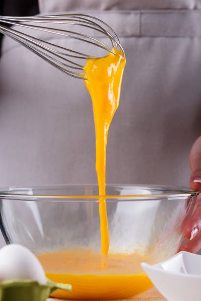 istock young woman in a gray aprons breaks the eggs 1144835771