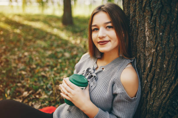 istock cute girl in a autumn park 1144835815