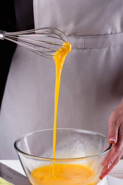 istock young woman in a gray aprons breaks the eggs 1144835822
