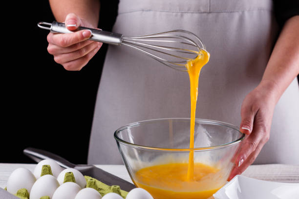 istock young woman in a gray aprons breaks the eggs 1144835825