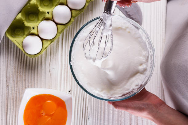 istock young woman in a gray aprons breaks the eggs 1144836195