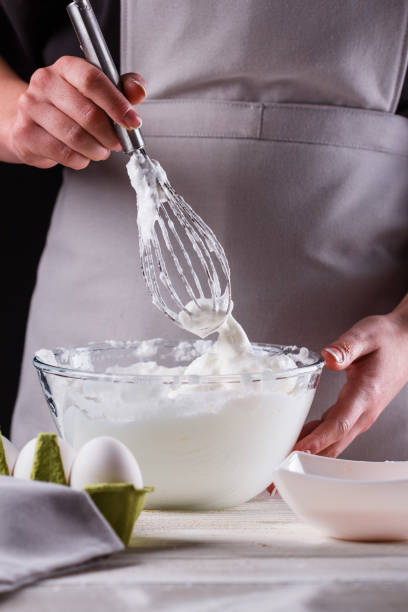 istock young woman in a gray aprons breaks the eggs 1144836221