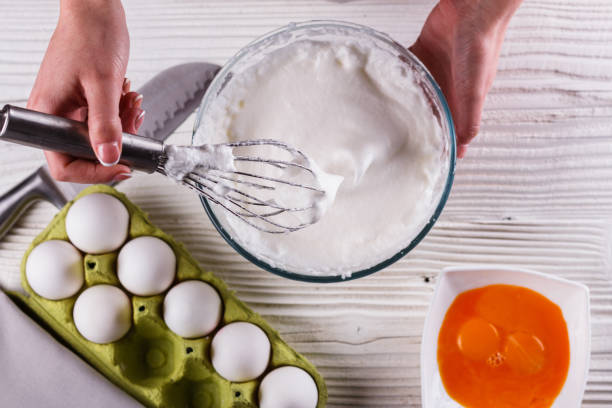 istock young woman in a gray aprons breaks the eggs 1144836223