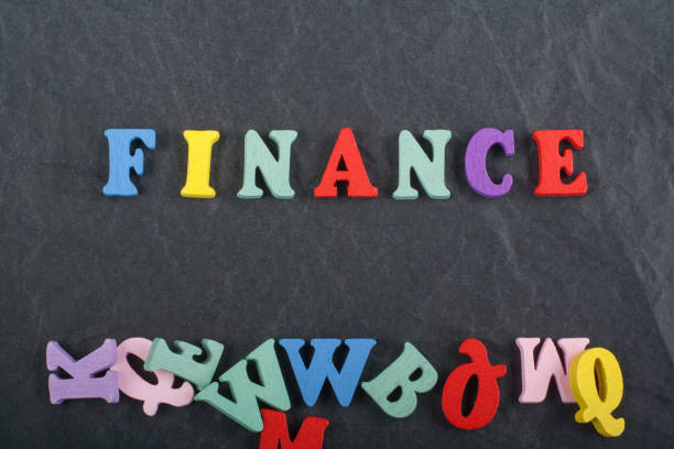 istock FINANCE word on black board background composed from colorful abc alphabet block wooden letters, copy space for ad text. Learning english concept. 1144839183