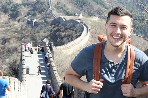 Handsome ethnic man in The Great Wall of China.