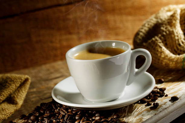 istock Coffee cup on wood background with coffee grain 1144840476