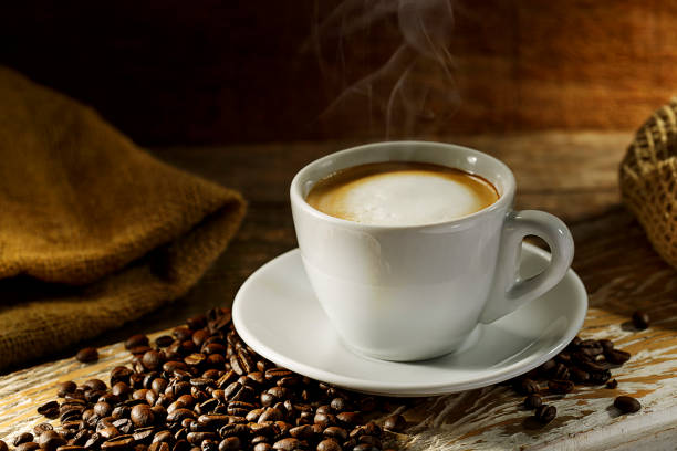 istock Coffee cup on wood background with coffee grain 1144840481