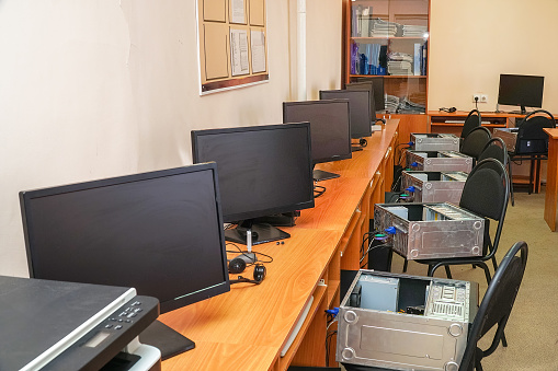 Empty computer repair class. The monitors on the tables