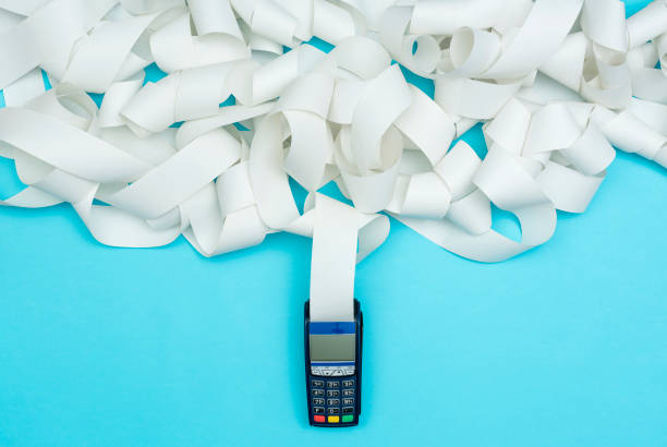 POS terminal with very long receipt POS terminal with very long receipt, expensive shopping concept receipt photos stock pictures, royalty-free photos & images