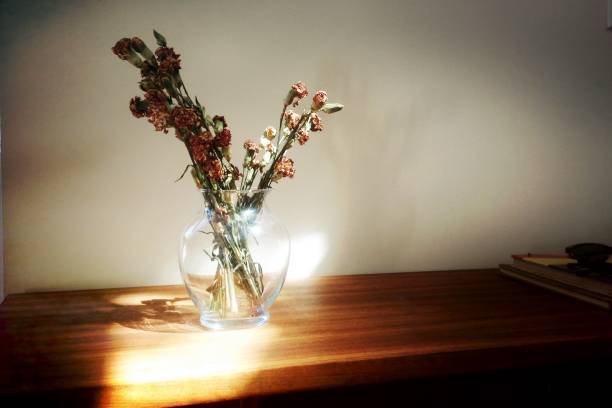 istock Wild flowers in glass vase with sun 1144844384