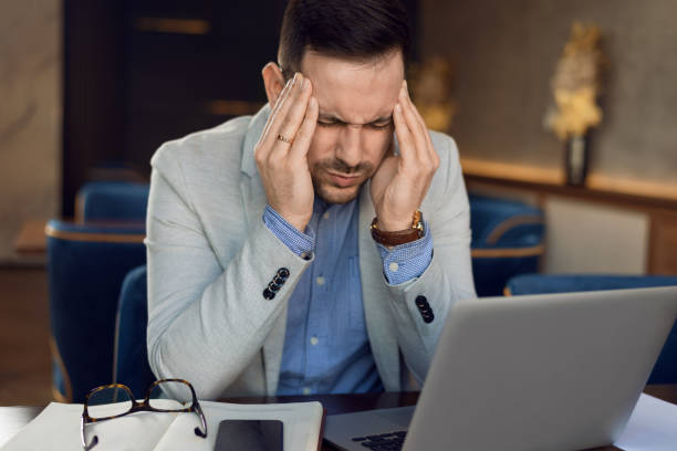 istock Exhausted businessman feeling pain after working on laptop. 1144849365