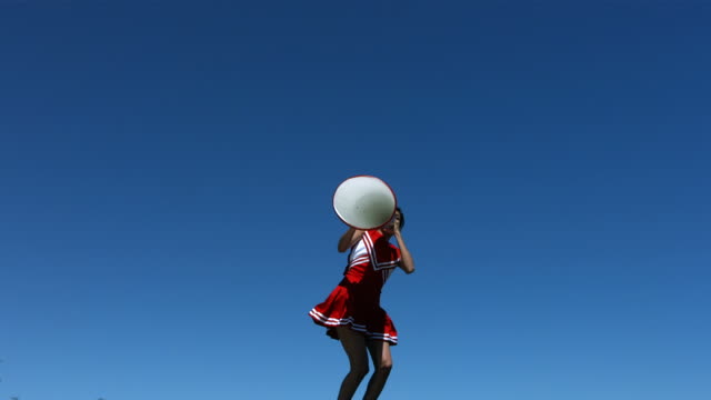 Cheerleader with megaphone, slow motion
