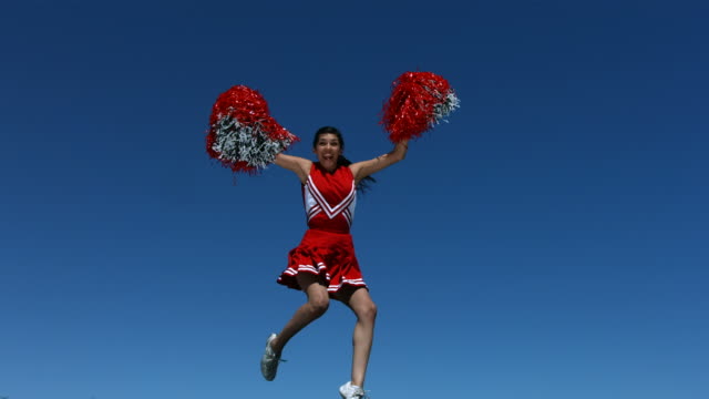 Cheerleader flies into the air, slow motion