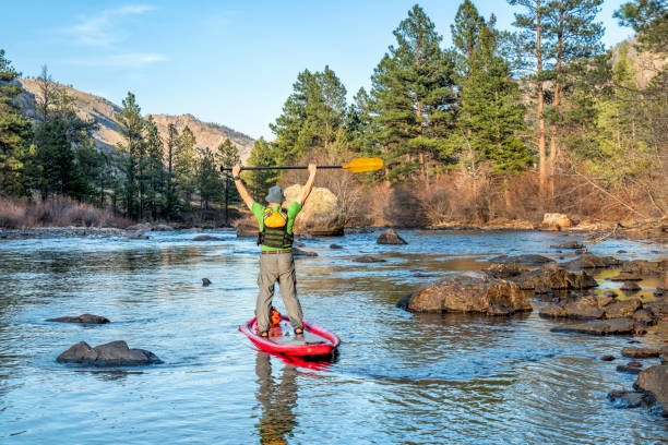 istock stand up paddling on mountain river 1144850294