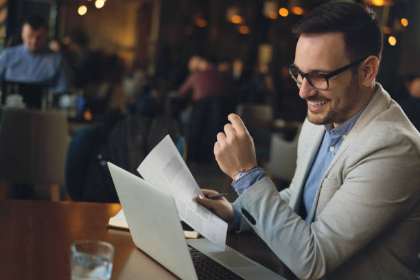 istock Young businessman going through reports in a cafe 1144850297