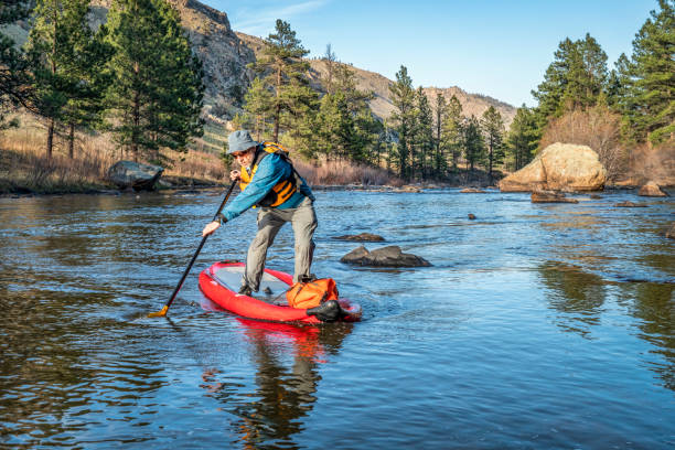 istock stand up paddling on mountain river 1144850592