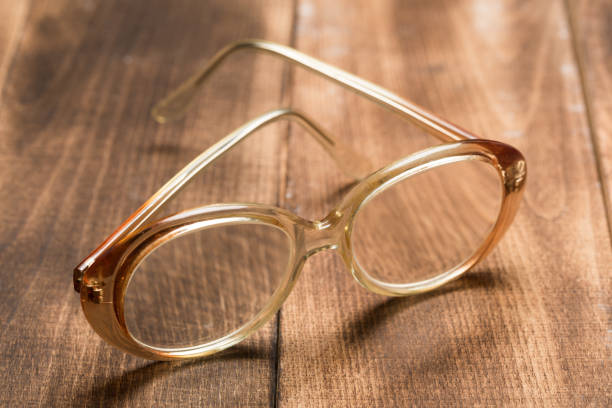 istock A pair of glasses on a wooden table 1144851803