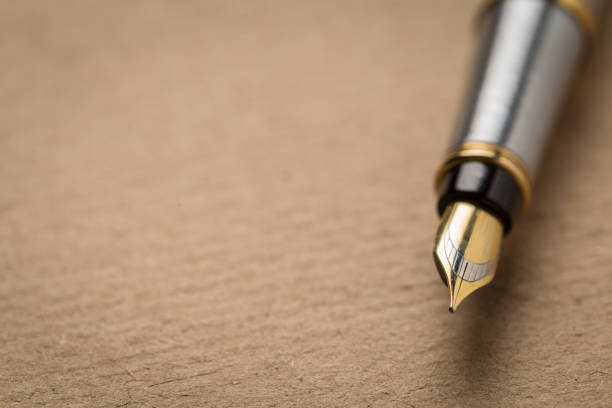 istock fountain pen on old paper. Vintage 1144851985