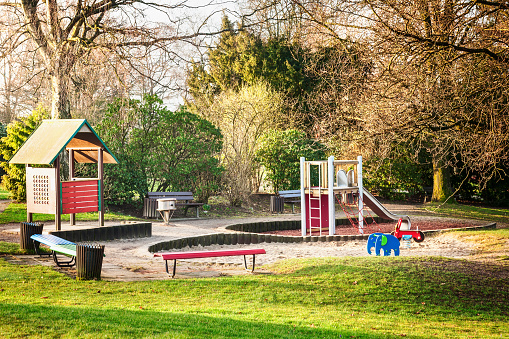 Playground in public city park. Early spring landscape and urban childhood concept