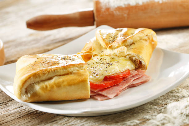 istock Ham and cheese calzones on wood background 1144853788