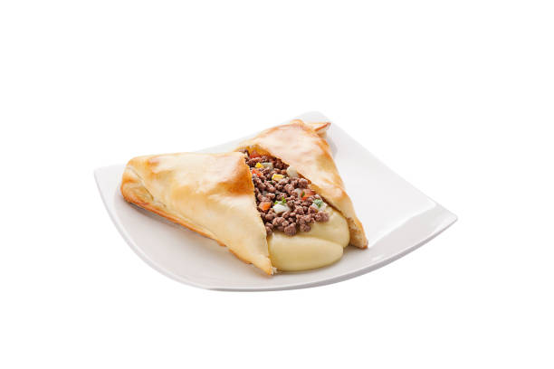 istock Salty calzones with dish on white background 1144854007