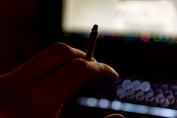 istock male hand holding a cigarette 1144854872