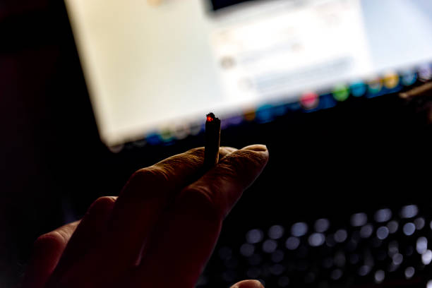 istock male hand holding a cigarette 1144855009