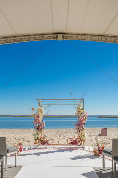 istock Event decoration. Wedding chuppa at riverside decorated with fresh flowers. Florist workflow 1144856249