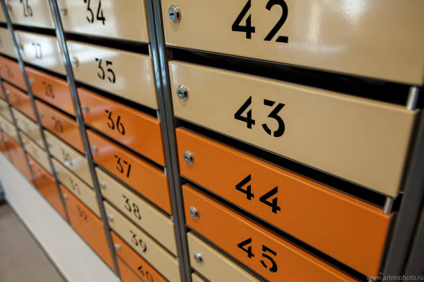 istock Row of metal yellow apartment mailboxes 1144856576