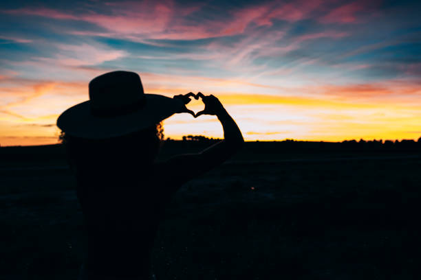 Woman silhouette in the beautiful sunset